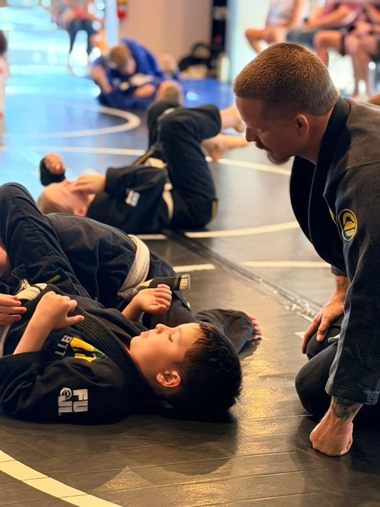A coach walking a young student through a technique