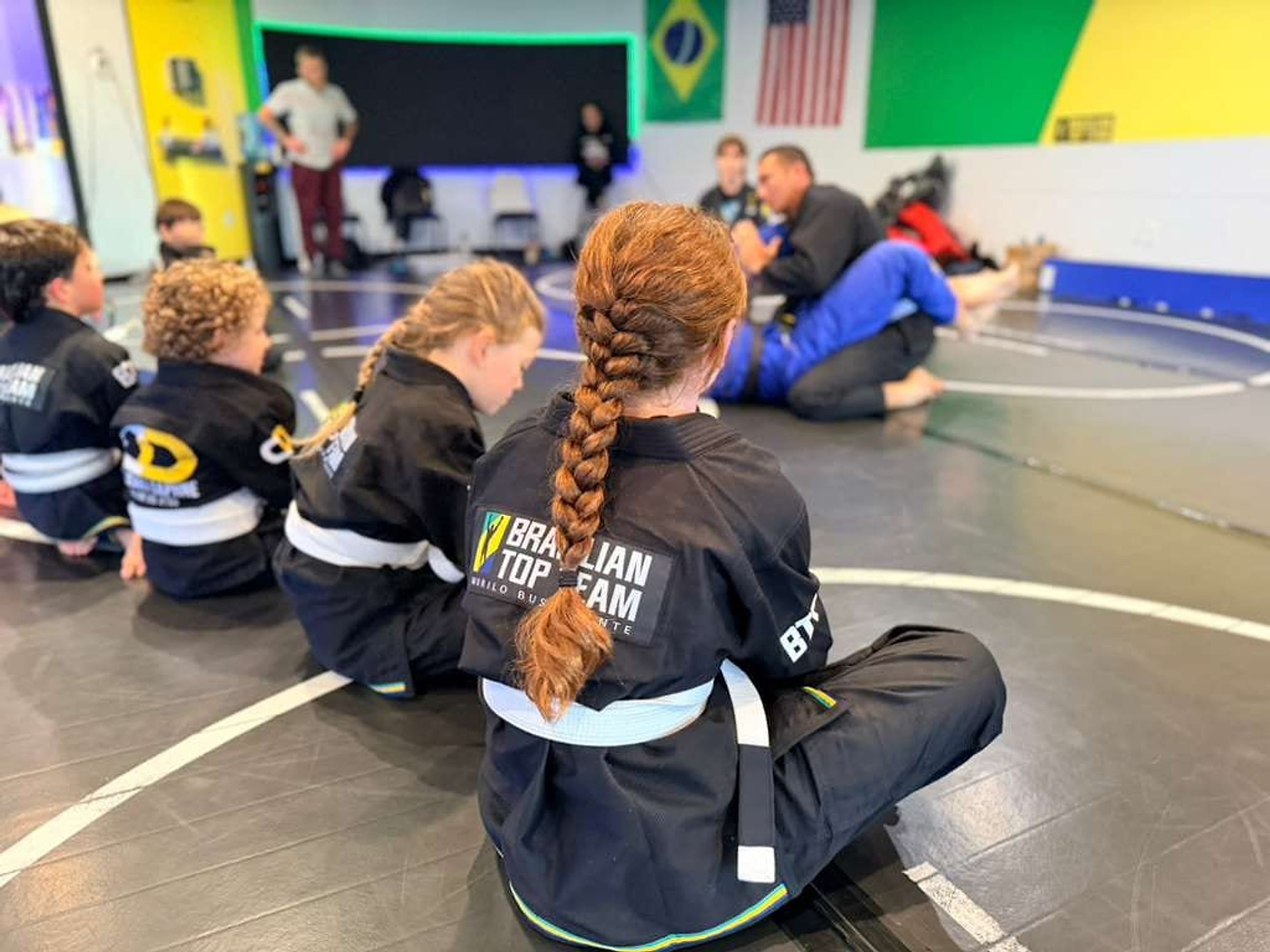 A student in a Brazilian Top Team gi during class