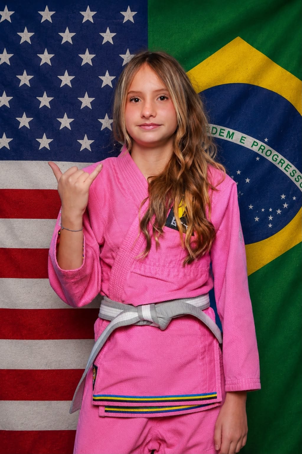 A young student photographed against the US and Brazilian flags
