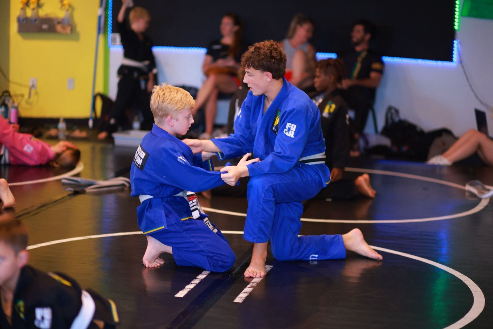 An older student helping a younger one
